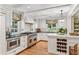 Eat-in kitchen with stainless steel appliances, dark countertops, an island, and white cabinets at 4590 Lake Forrest Nw Dr, Atlanta, GA 30342