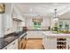 Stylish kitchen with stainless steel appliances, subway tile backsplash, and marble-topped island at 4590 Lake Forrest Nw Dr, Atlanta, GA 30342
