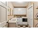 Functional laundry room features modern washer and dryer, sink, and ample cabinet space at 4590 Lake Forrest Nw Dr, Atlanta, GA 30342