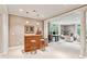 Open concept living room with columns, bamboo bar, and multiple seating areas at 4590 Lake Forrest Nw Dr, Atlanta, GA 30342