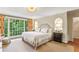 Bright main bedroom with large windows, hardwood floors, and elegant decor, creating a peaceful and inviting space at 4590 Lake Forrest Nw Dr, Atlanta, GA 30342