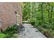 Outdoor patio offers a relaxing space surrounded by lush greenery and mature trees at 4590 Lake Forrest Nw Dr, Atlanta, GA 30342