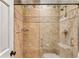 Tiled shower with glass door and decorative border creating an elegant design at 4590 Lake Forrest Nw Dr, Atlanta, GA 30342