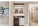 Convenient wet bar featuring glass cabinet and mini-fridge, perfect for entertaining guests at 4590 Lake Forrest Nw Dr, Atlanta, GA 30342