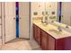 This bathroom offers a double sink, and tiled floors and backsplash at 5649 Cobblestone Creek Pl # 13, Mableton, GA 30126
