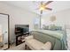 Bedroom featuring a lighted ceiling fan, a wall mounted television, and large windows at 5649 Cobblestone Creek Pl # 13, Mableton, GA 30126