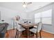 Bright dining area boasts a ceiling fan, wood floors, and a table with seating for four at 5649 Cobblestone Creek Pl # 13, Mableton, GA 30126