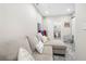 Relax in this living area near a guest bathroom, featuring a comfortable couch and modern accents at 5649 Cobblestone Creek Pl # 13, Mableton, GA 30126