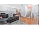 Inviting living room with hardwood floors, a plush sectional sofa, and a staircase leading to the upper level at 5649 Cobblestone Creek Pl # 13, Mableton, GA 30126