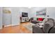 Cozy living room with hardwood floors, large sectional sofa, and modern decor at 5649 Cobblestone Creek Pl # 13, Mableton, GA 30126