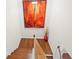View from the top of the staircase showcasing the wooden steps and colorful wall art at 5649 Cobblestone Creek Pl # 13, Mableton, GA 30126