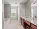 Bright bathroom featuring double sink vanity, soaking tub with large window and neutral decor at 840 Ash St, Canton, GA 30114