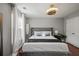 Comfortable bedroom with a queen bed, cherry wood floor, natural light, and a stylish ceiling fan at 840 Ash St, Canton, GA 30114