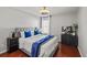 Comfortable bedroom features hardwood floors, a ceiling fan, a large bed, and neutral decor at 840 Ash St, Canton, GA 30114