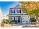 Charming two-story home featuring gray siding, black shutters, a welcoming front porch, and a manicured front yard at 840 Ash St, Canton, GA 30114