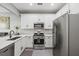 Bright kitchen featuring stainless steel appliances, white cabinets, quartz counters, and an adjacent dining area at 840 Ash St, Canton, GA 30114