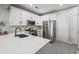 Well-lit kitchen boasts stainless steel appliances, white cabinetry, and quartz countertops at 840 Ash St, Canton, GA 30114