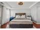 Comfortable main bedroom with neutral decor, plush bedding, wood floors, and tray ceiling with fan at 840 Ash St, Canton, GA 30114