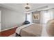 Serene main bedroom with cozy seating, wood floors, neutral walls, and abundant natural light at 840 Ash St, Canton, GA 30114
