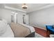 Bright main bedroom showcasing tray ceilings, wood floors, ensuite bathroom access and neutral decor at 840 Ash St, Canton, GA 30114