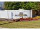 Landscaped community sign, 'Hidden Springs', set in a brick wall at 840 Ash St, Canton, GA 30114
