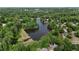 An aerial view featuring a serene lake, lush greenery, and charming houses nestled within a vibrant community at 138 Grand Ave, Suwanee, GA 30024