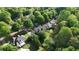 Aerial view showcases the home's location nestled amongst lush greenery and mature trees in a quiet neighborhood at 138 Grand Ave, Suwanee, GA 30024