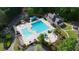 Aerial view of community pool with clubhouse, lounge chairs, and shade at 138 Grand Ave, Suwanee, GA 30024