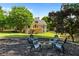 Landscaped backyard featuring a stone fire pit surrounded by Adirondack chairs, ideal for relaxing evenings at 138 Grand Ave, Suwanee, GA 30024