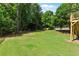 Spacious backyard features a well-maintained lawn and a wooden fence, providing a serene outdoor setting at 138 Grand Ave, Suwanee, GA 30024