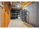 Unfinished basement with concrete walls and metal shelves ready for storage at 138 Grand Ave, Suwanee, GA 30024