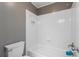 Clean and bright bathroom with tub/shower combination, toilet, and single sink vanity at 138 Grand Ave, Suwanee, GA 30024