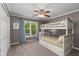 Comfortable bedroom with bunk beds, ceiling fan, window with curtains, and ample closet space at 138 Grand Ave, Suwanee, GA 30024
