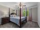 Charming bedroom featuring a four poster bed, side table and natural light from large windows at 138 Grand Ave, Suwanee, GA 30024