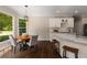 Bright breakfast nook featuring hardwood floors, a stylish light fixture, and a view of the lush backyard at 138 Grand Ave, Suwanee, GA 30024