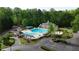 Community pool with cabana, lounge chairs, umbrellas, and parking are surrounded by trees and landscaping at 138 Grand Ave, Suwanee, GA 30024