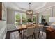 Elegant dining room with neutral walls, modern chandelier, and ample natural light at 138 Grand Ave, Suwanee, GA 30024