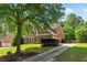 A lovely brick home with a well-manicured front yard and a long driveway at 138 Grand Ave, Suwanee, GA 30024