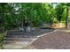 Cozy fire pit area in the backyard, surrounded by seating and mature trees, creating a private outdoor retreat at 138 Grand Ave, Suwanee, GA 30024