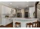 Bright, modern kitchen with marble countertops, white cabinets, and stainless steel appliances at 138 Grand Ave, Suwanee, GA 30024