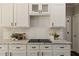 Kitchen counter with white subway tile backsplash, marble counters, and stainless appliances at 138 Grand Ave, Suwanee, GA 30024