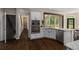 Modern kitchen featuring stainless steel appliances and white cabinets with a view to the staircase at 138 Grand Ave, Suwanee, GA 30024