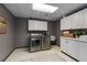 Bright laundry room featuring stainless steel washer and dryer and ample white cabinet storage space at 138 Grand Ave, Suwanee, GA 30024