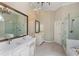 Elegant main bathroom with double vanity, shower, soaking tub, and chandelier at 138 Grand Ave, Suwanee, GA 30024