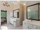 Luxurious bathroom with double vanities, a soaking tub, and a glass-enclosed shower at 138 Grand Ave, Suwanee, GA 30024