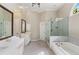 Bright main bathroom with double sinks, marble countertops, a glass-enclosed shower, and a soaking tub at 138 Grand Ave, Suwanee, GA 30024