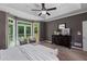 Tranquil main bedroom with a tray ceiling, sitting area, neutral decor, and outdoor views at 138 Grand Ave, Suwanee, GA 30024