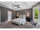 Large main bedroom with a tray ceiling, carpet, and access to the en suite bathroom at 138 Grand Ave, Suwanee, GA 30024