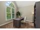 Bright home office with large arched window, desk, and a bookcase at 138 Grand Ave, Suwanee, GA 30024