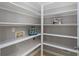 Spacious pantry featuring ample shelving for organized storage solutions and easy access to household goods at 138 Grand Ave, Suwanee, GA 30024